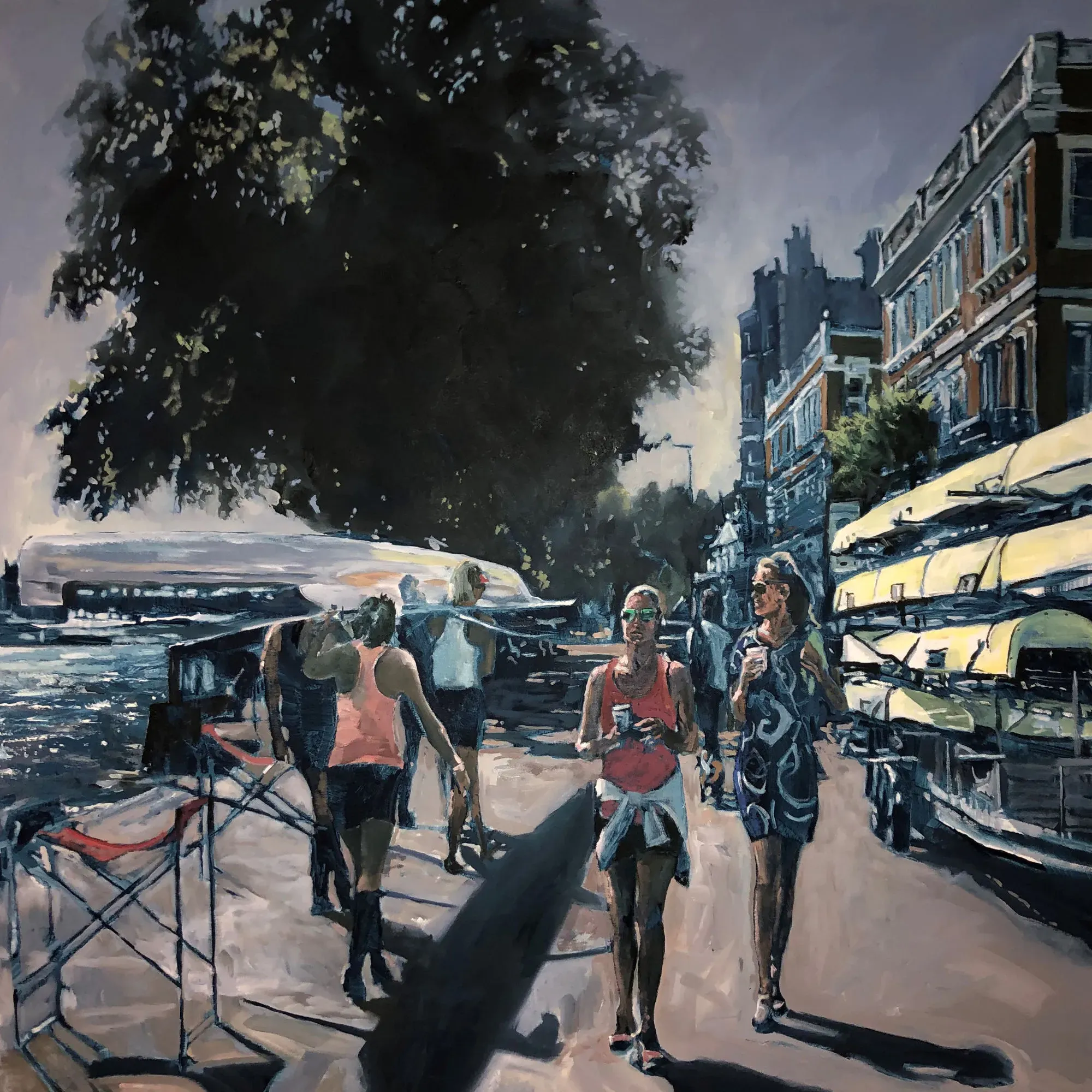 Two pedestrians with coffee walking past rowers preparing to enter the water.