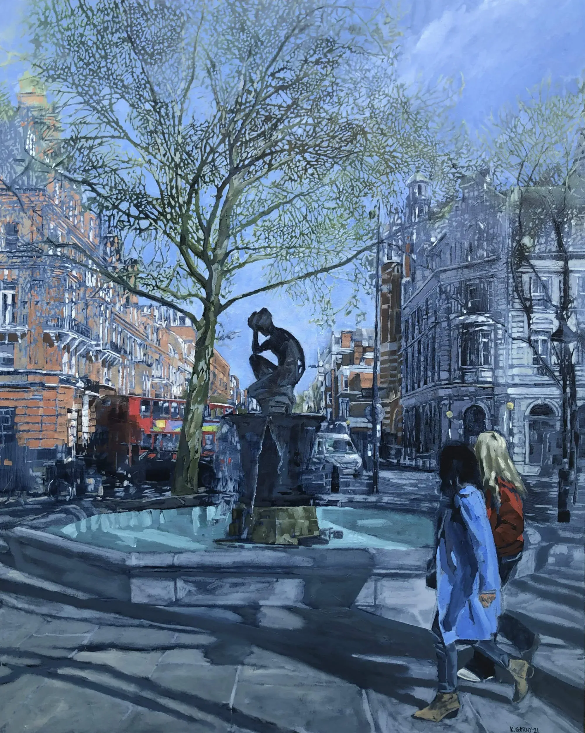 Two pedestrians walking past the fountain in London's Sloane Square.