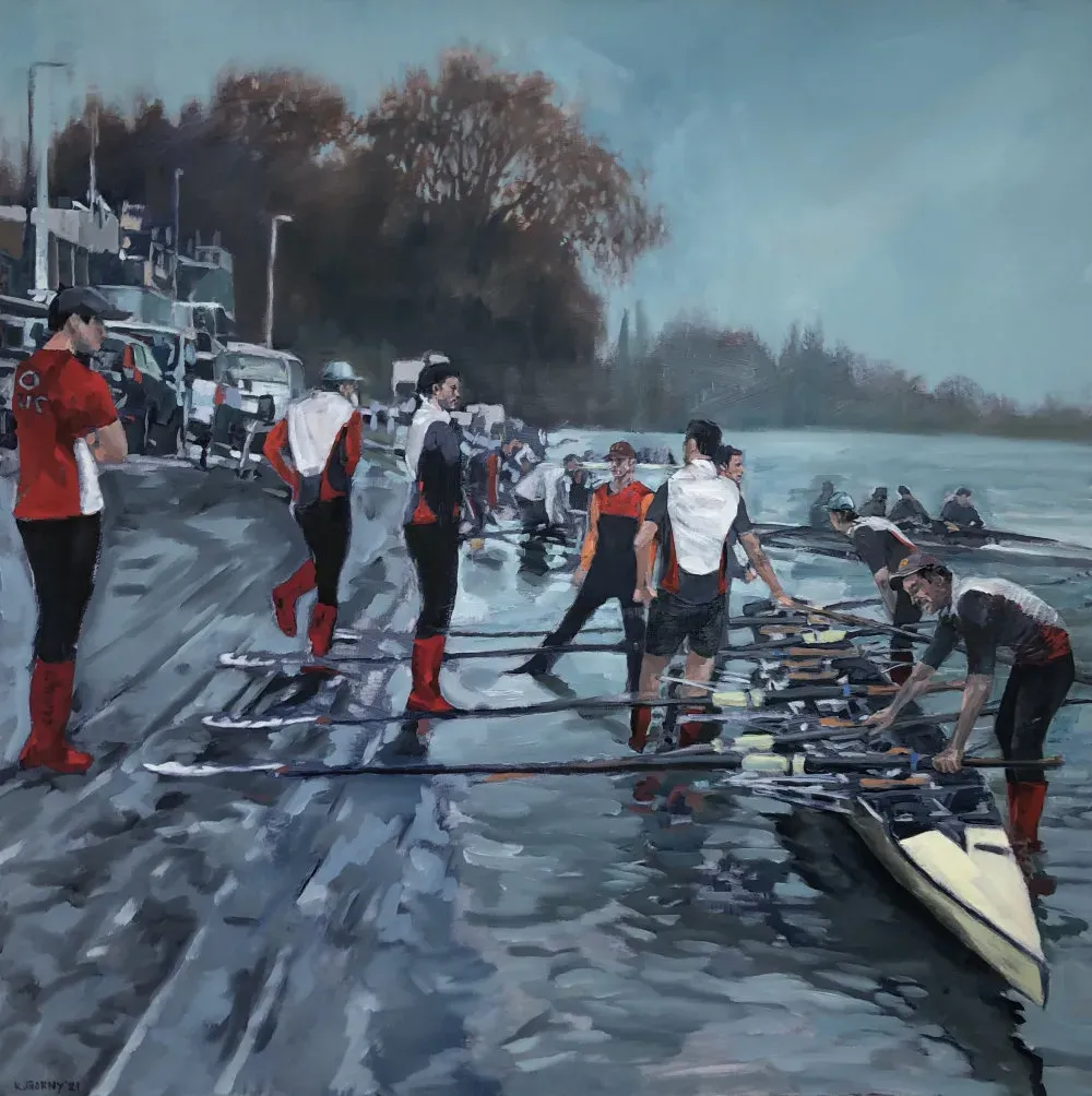 Rowers in bright kit readying their boats on Putney Embankment on a blue-grey morning.